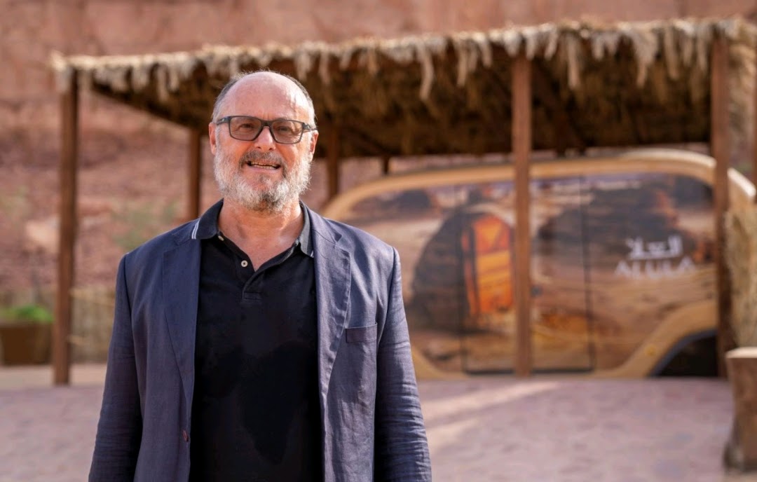 Andrew Rippon at AlUla with an autonomous shuttle in the background